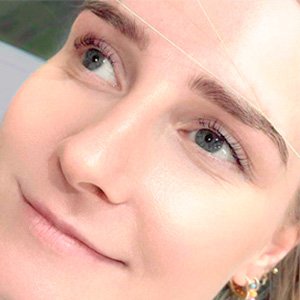 Mujer a la que se le hace un mantenimiento de cejas